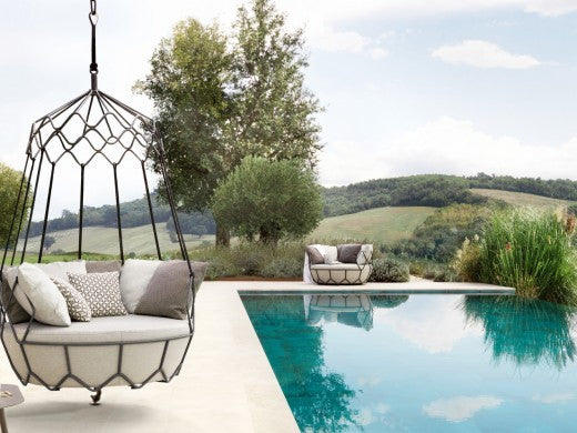 Roberti Gravity 9881 graphite hanging sofa beside a pool and landscape