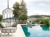Roberti Gravity 9881 graphite hanging sofa beside a pool and landscape