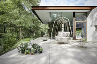 Roberti Gravity 9884 light hanging sofa with supporting frame in a modern outdoor setting