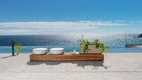 Roberti Key West round poufs beside the beam system overlooking the sea