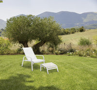 Roberti Playa armchair and pouf in a landscaped outdoor setting