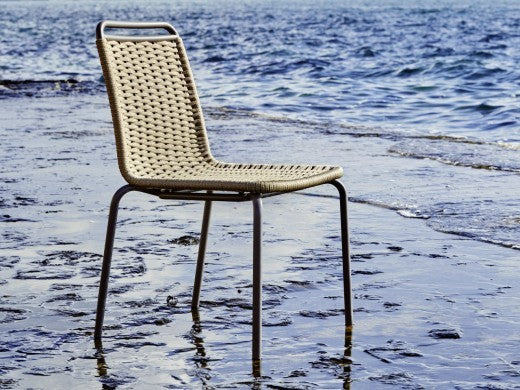 Roberti Portofino woven dining chair beside the sea