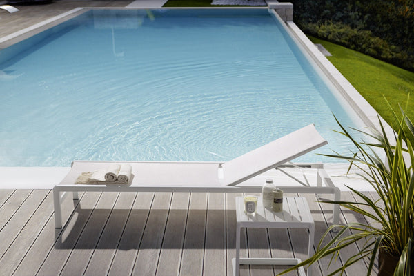 Roberti Samba Rio sunbed with side table beside a pool