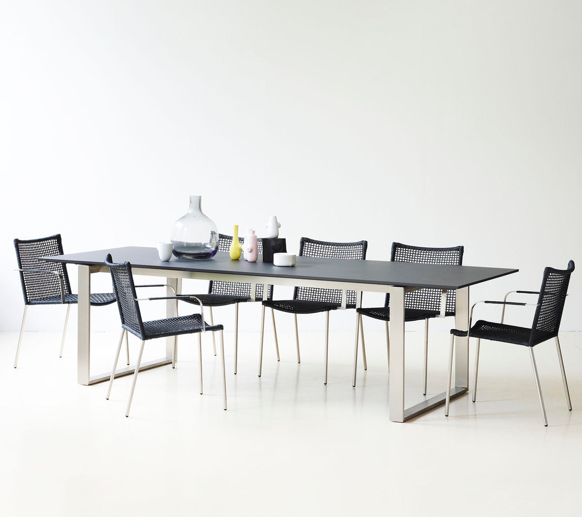 Straw dining chair with armrest by Cane-line, designed by Foersom & Hiort-Lorenzen MDD