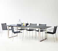 Straw dining chair with armrest by Cane-line, designed by Foersom & Hiort-Lorenzen MDD