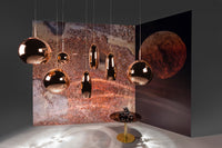Tom Dixon Copper pendant family in a warm metallic lighting installation