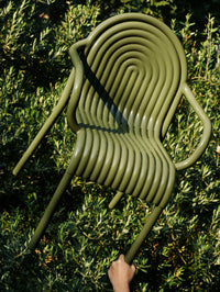 Tom Dixon Groove Outdoor Arm Chair in an outdoor lifestyle setting