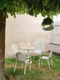 Tom Dixon Groove Outdoor Arm Chair in an outdoor lifestyle setting