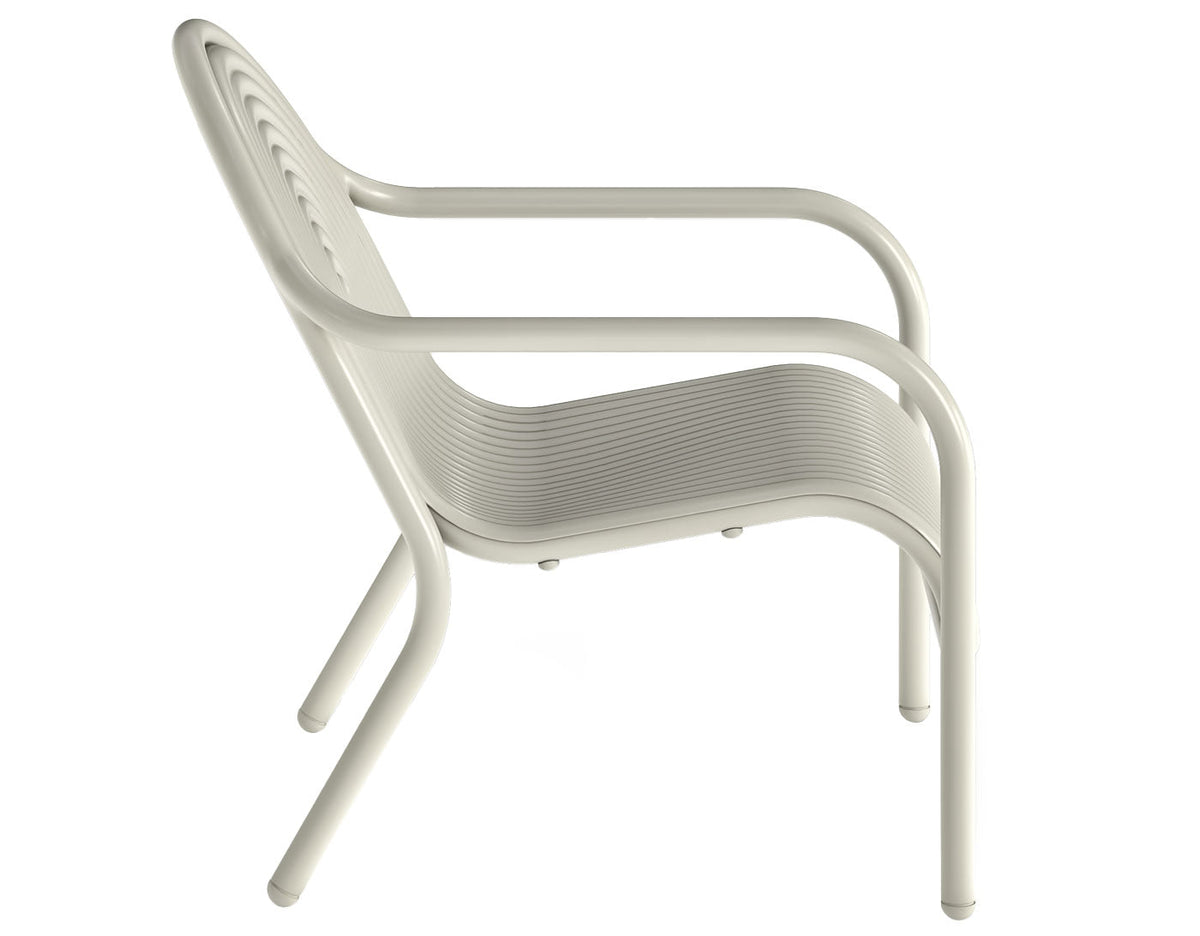 Tom Dixon Groove Outdoor Lounge Chair in a garden lifestyle setting