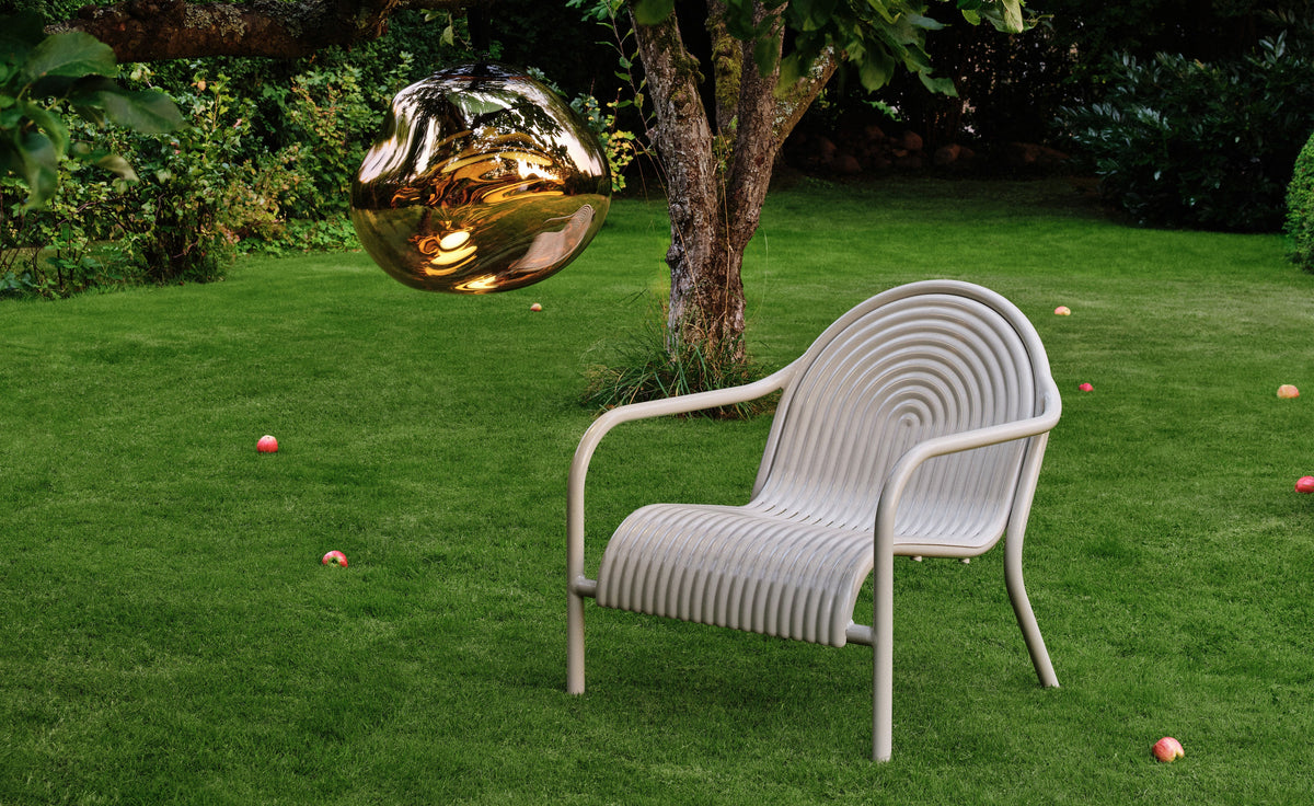 Tom Dixon Groove Outdoor Lounge Chair in a garden lifestyle setting