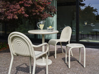 Tom Dixon Groove Outdoor Small Round Table in an outdoor dining setting