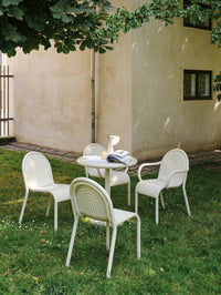 Tom Dixon Groove Outdoor Small Round Table in an outdoor dining setting