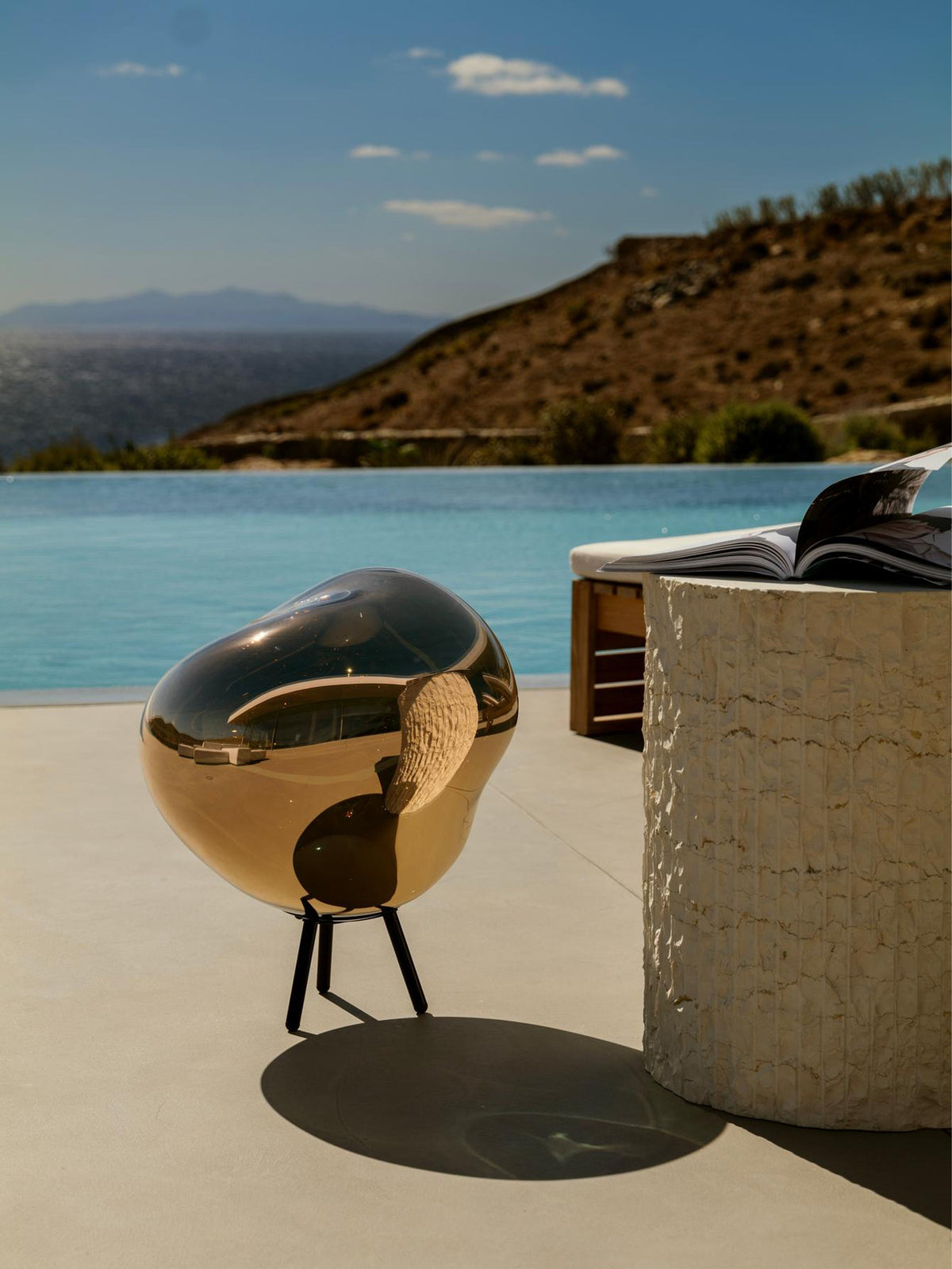Melt Large Portable Light by Tom Dixon in an outdoor setting