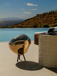 Melt Large Portable Light by Tom Dixon in an outdoor setting