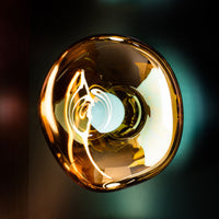 Tom Dixon Melt Medium Surface Light in gold in an interior installation