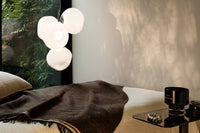 Tom Dixon Melt Mini Chandelier in opal with silver hardware in an interior