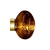 Tom Dixon Melt Mini Surface Light in gold, illuminated side view
