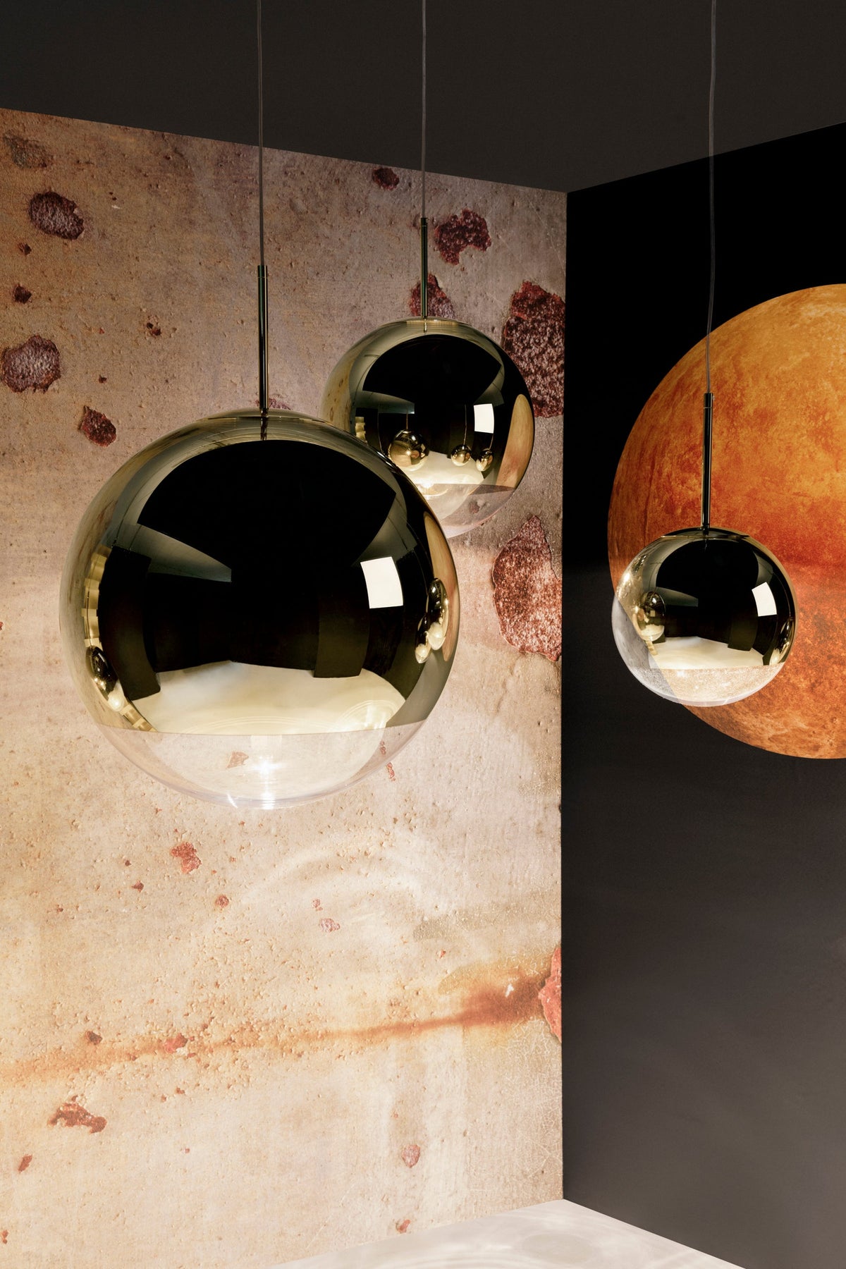 Tom Dixon Mirror Ball gold pendants in a vertical lighting installation