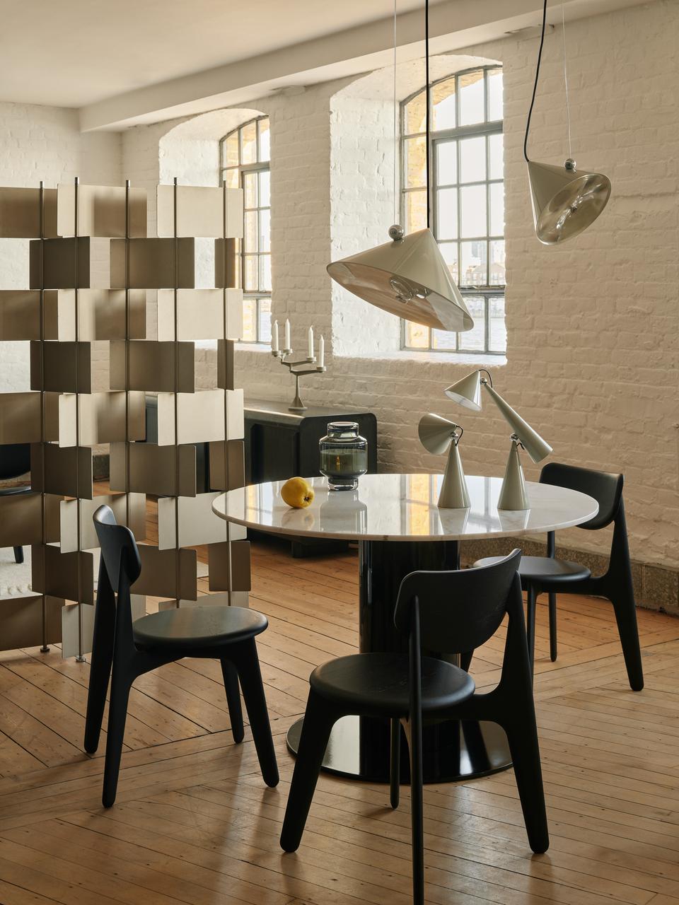 Tom Dixon Pose Pendants in Polished Silver in a modern dining room