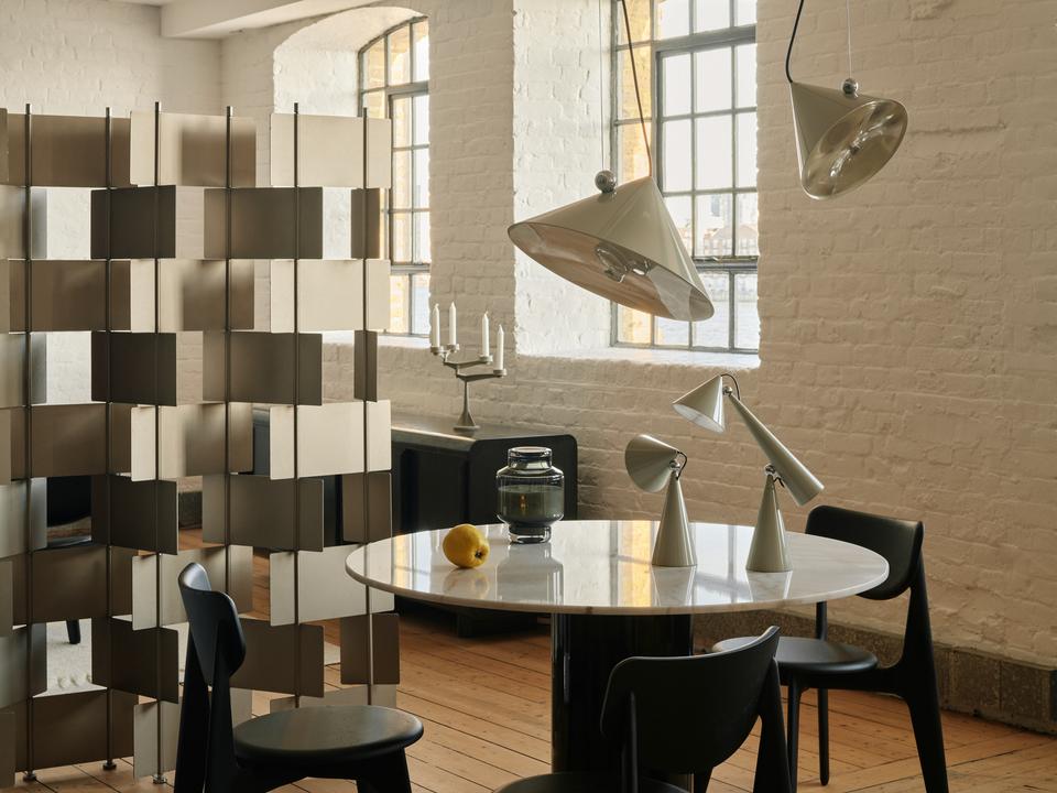 Tom Dixon Pose Pendants in Polished Silver above a dining table