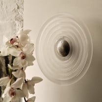 Tom Dixon Press Large Surface Light in frosted glass installed on a wall