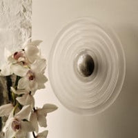 Tom Dixon Press Large Surface Light in frosted glass installed on a wall