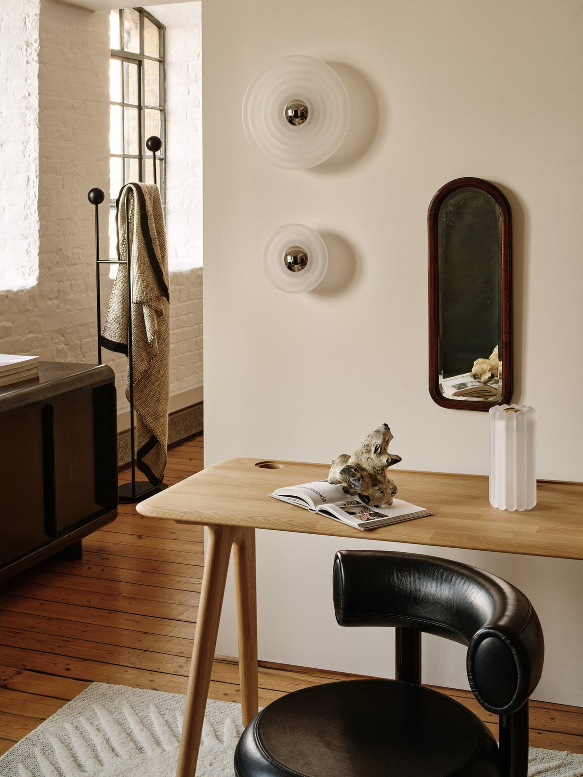 Tom Dixon Press Mini Surface Light in frosted pressed glass in an architectural interior