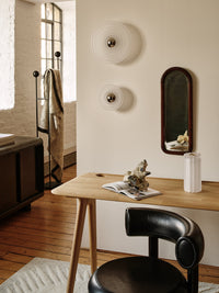 Tom Dixon Press Mini Surface Light in frosted pressed glass in an architectural interior