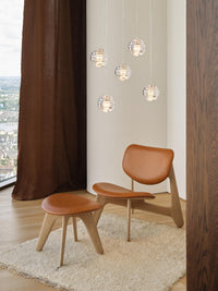 Tom Dixon Press Mini Sphere clear pendants in a clustered installation