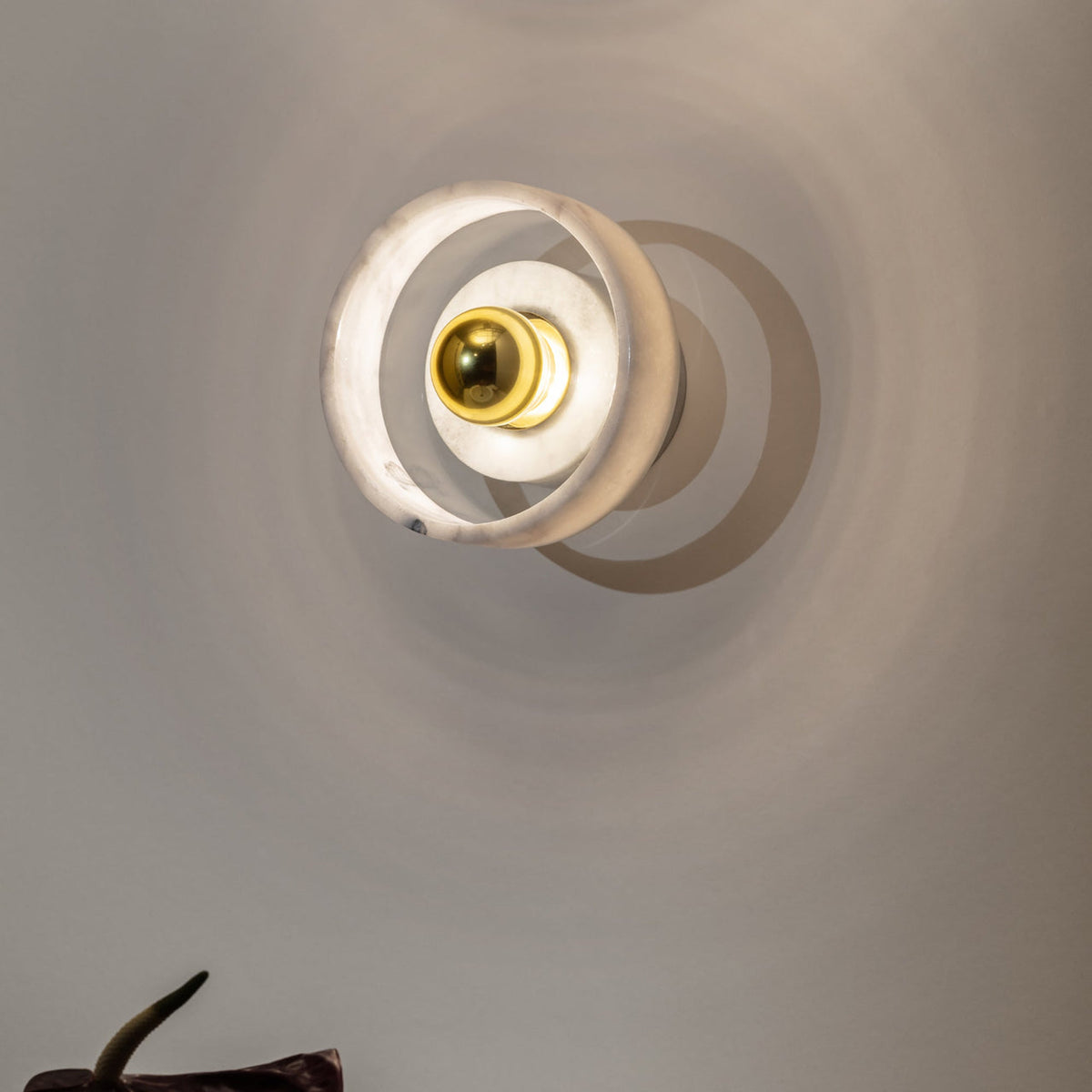 Tom Dixon Stone Wall Light in a residential interior