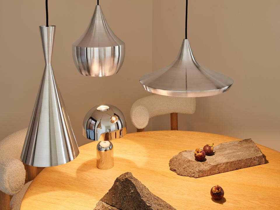 Tom Dixon Unbeaten pendant family above a modern dining table