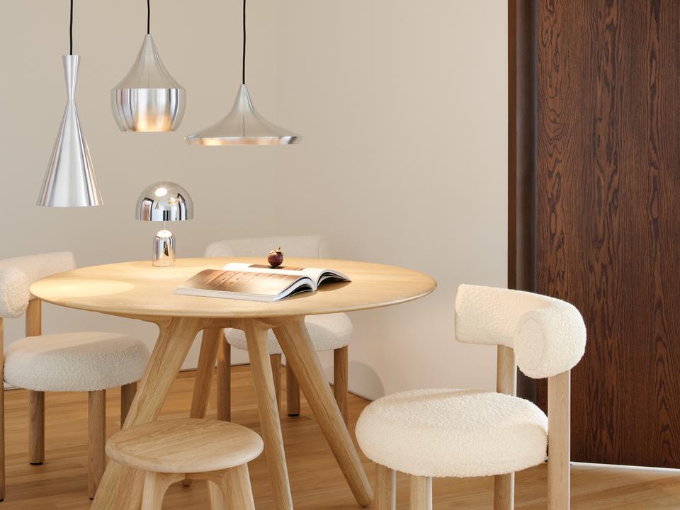 Tom Dixon Unbeaten pendant family above a round wood table