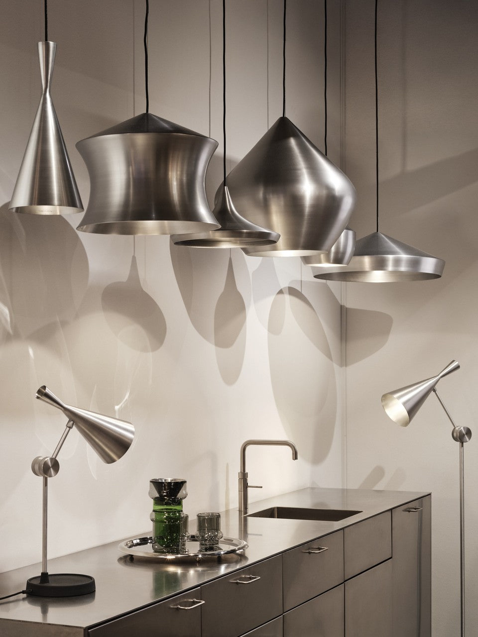Tom Dixon Unbeaten pendant family displayed in a modern showroom