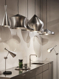Tom Dixon Unbeaten pendant family displayed in a modern showroom