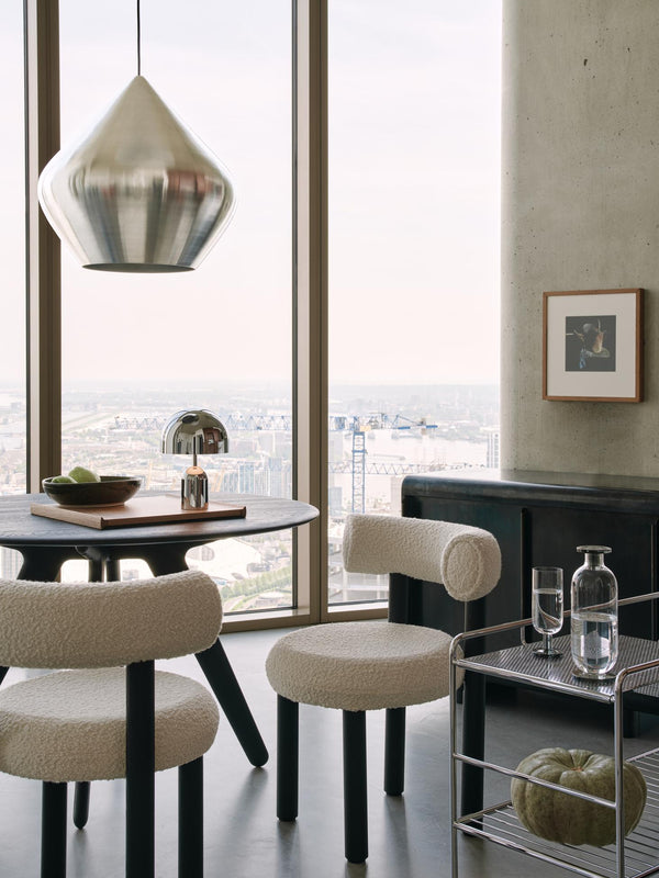 Tom Dixon Unbeaten Stout Pendant above a modern dining area