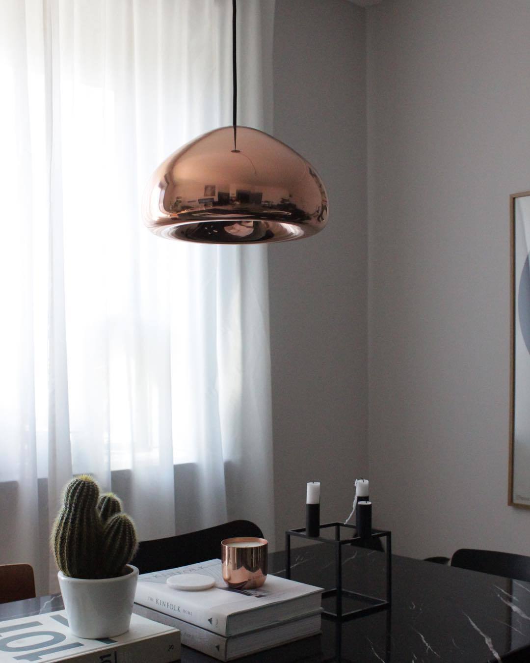 Tom Dixon Void Medium Pendant in polished copper in a modern bedroom