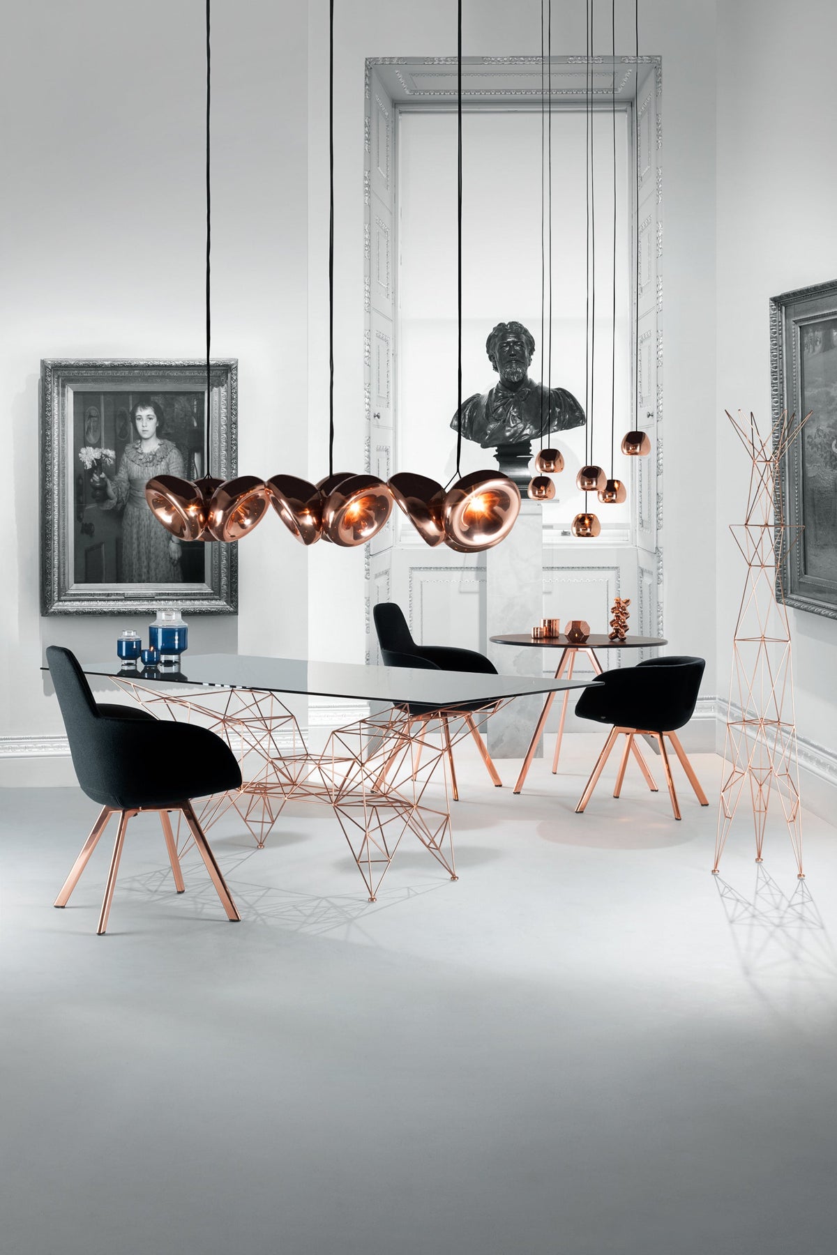 Tom Dixon Void copper pendants above a modern dining table