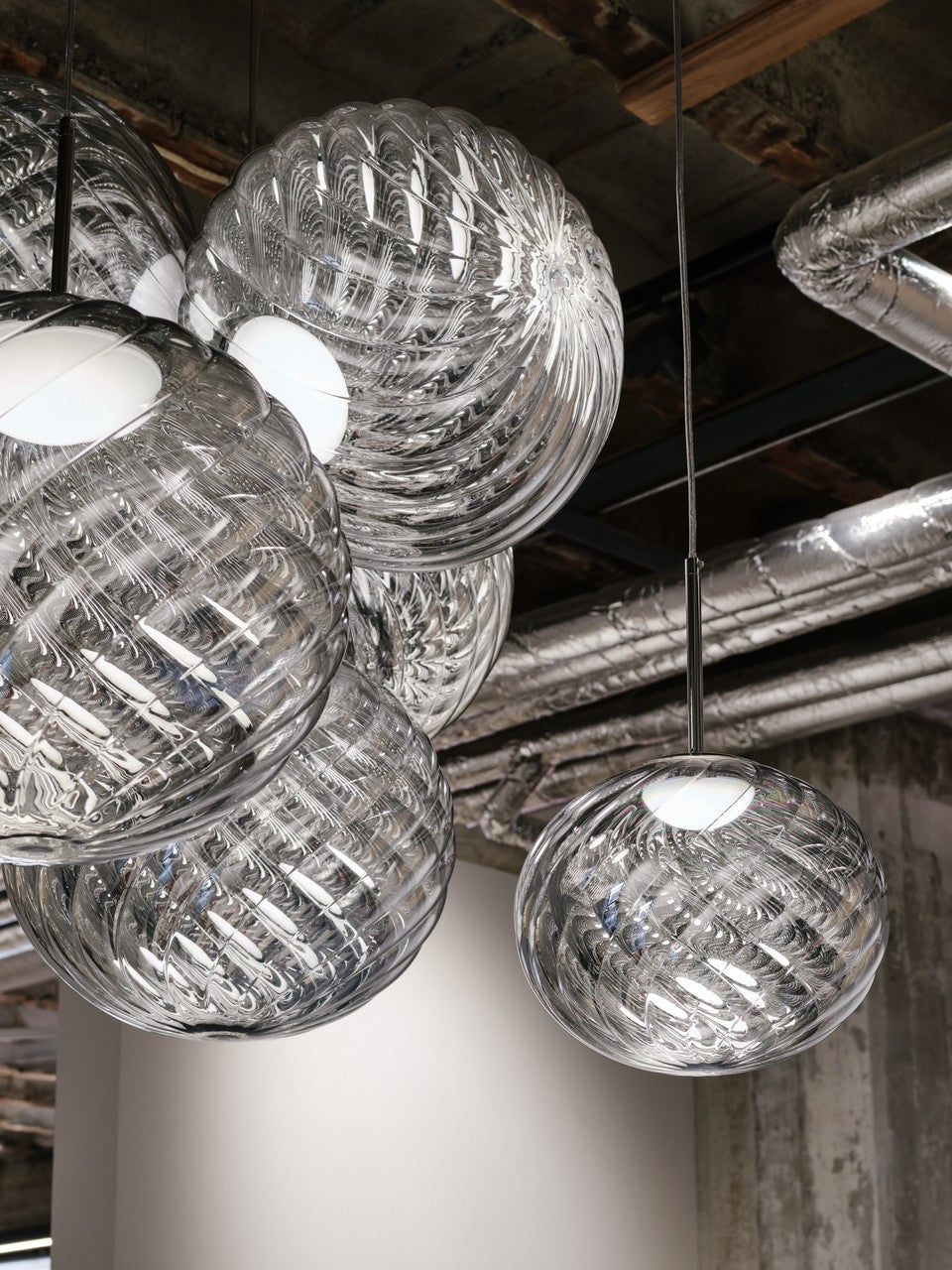 Tom Dixon Whirl silver pendants in a hanging installation