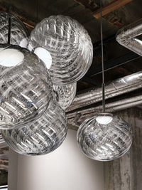Tom Dixon Whirl silver pendants in a hanging installation