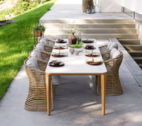 Basket chair outdoor dining setting by Cane-line
