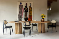 Maru oval dining table with Titus dining chairs in an interior